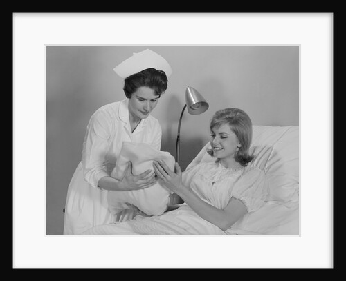 Woman nurse giving baby to smiling mother patient sitting in hospital bed by Anonymous