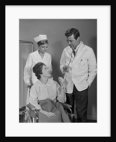 Man doctor woman nurse talking to smiling female patient sitting in hospital wheelchair by Anonymous