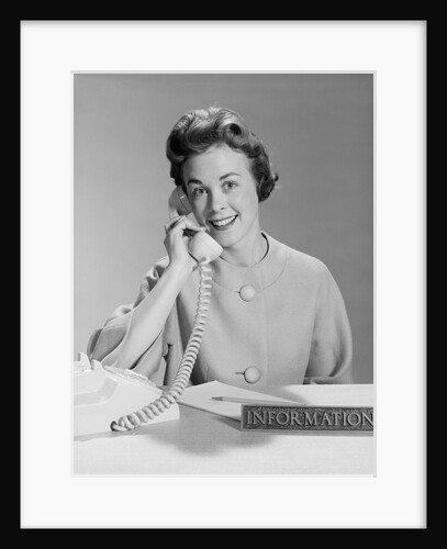 Smiling woman secretary talking on telephone information desk by Anonymous