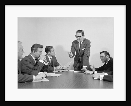 5 executive businessmen meeting at conference table one man standing by Anonymous