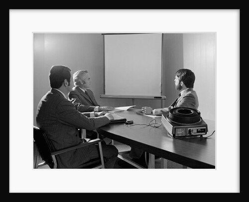Three executive businessmen conference table audiovisual presentation by Anonymous