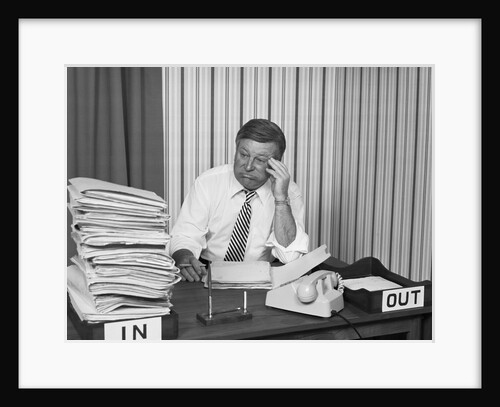 Concerned businessman staring large pile paperwork in in-box by Anonymous