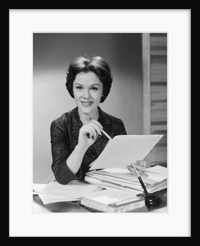 Portrait smiling executive woman holding files papers by Anonymous