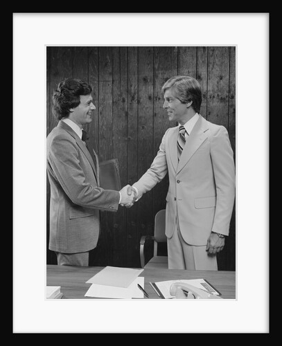 Two businessmen shaking hands handshake by Anonymous
