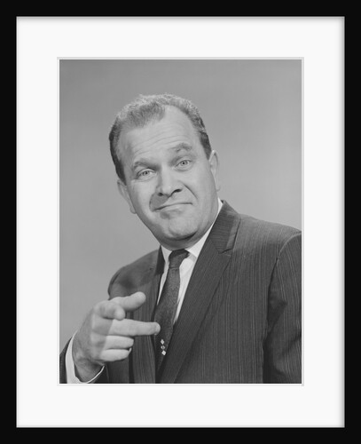 Portrait man pointing wearing suit tie smiling by Anonymous