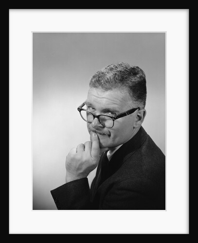 Middle aged man wearing eyeglasses low on nose quizzical facial expression by Anonymous