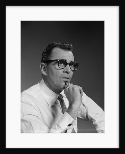 Man thinking hand pencil on chin wearing eyeglasses serious expression by Anonymous