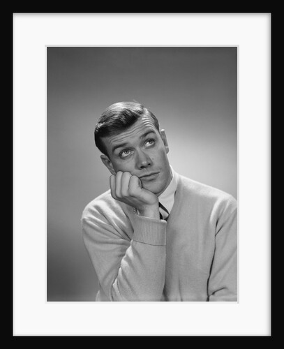 Young man hand to cheek looking up quizzical wondering thoughtful facial expression by Anonymous