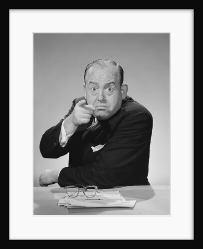 Angry businessman pointing finger bulging staring eyes wide open by Anonymous
