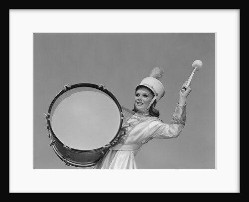 Smiling young woman band uniform carrying playing big drum by Anonymous