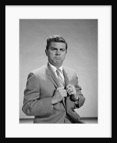 Portrait middle aged man stern serious expression hands gripping his lapels by Anonymous