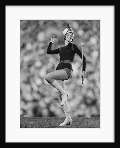 Smiling young woman majorette white boots hot pants marching by Anonymous