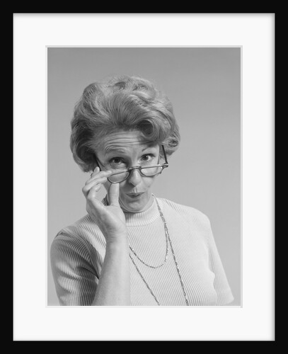 Mature woman looking over the top of her eyeglasses funny facial expression by Anonymous