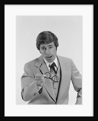 Businessman serious expression pointing with eyeglasses by Anonymous