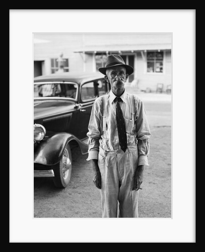 Portrait of old man wearing hat glasses tie & suspenders car in background by Anonymous
