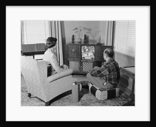 Couple husband wife watching console television in living room by Anonymous