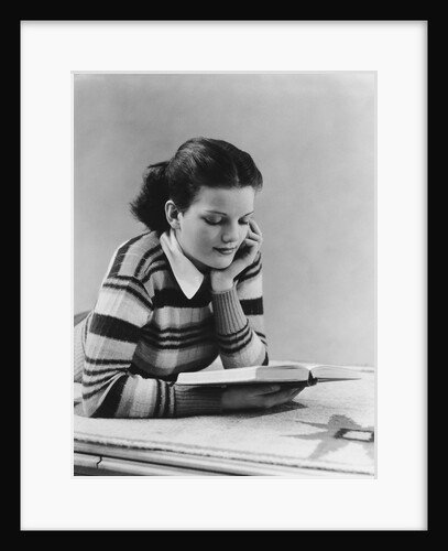 Young brunette woman teen striped sweater reading book studying by Anonymous