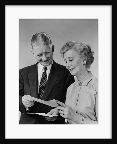 Senior couple man woman reading holding check by Anonymous