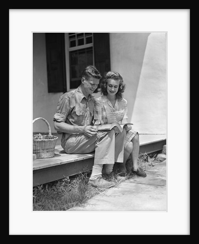 Man woman sitting on porch of farmhouse reading catalog by Anonymous
