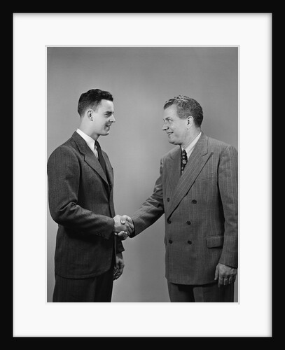 Two business men of different generations shaking hands by Anonymous