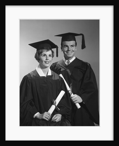 Portrait couple man woman in graduation robes holding diplomas smiling by Anonymous
