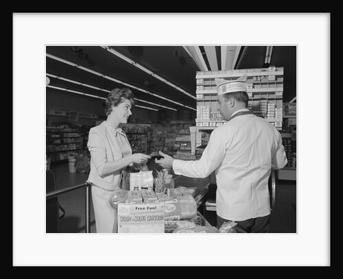 Woman paying at grocery store checkout male cashier by Anonymous
