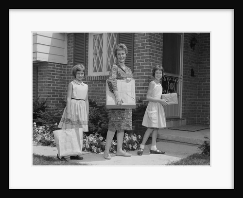 Mother and two daughters carrying shopping bags packages into house by Anonymous