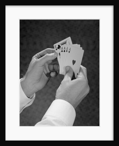 Male hands holding hand poker cards 4 aces and a king by Anonymous