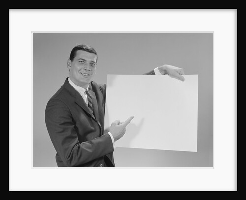 Smiling man pointing to blank poster by Anonymous