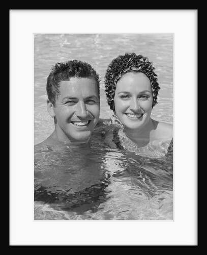 Smiling couple man woman in swimming pool by Anonymous