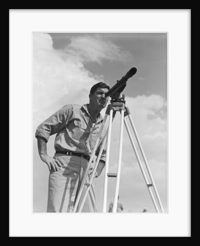 Man using a theodolite while surveying by Anonymous