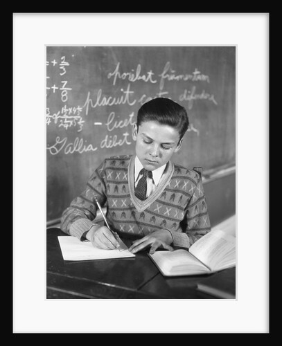 Boy vee neck sweater writing at school desk by Anonymous