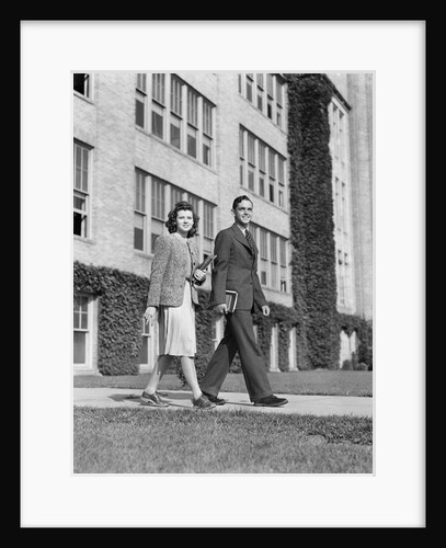 College couple walking on campus before ivy covered building by Anonymous