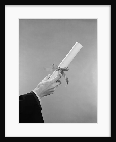 Male hand holding graduation diploma by Anonymous