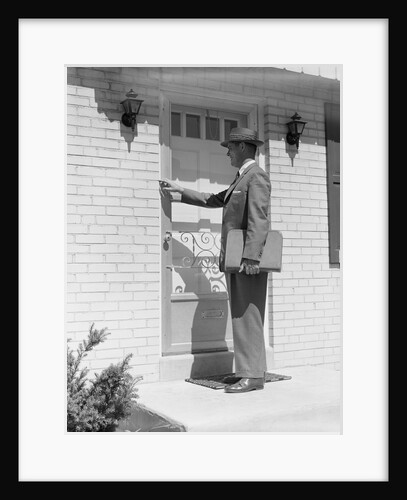 Salesman wearing suit tie hat carrying briefcase ringing suburban house doorbell by Anonymous