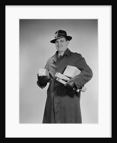 Man wearing winter coat hat gloves holding packages parcels by Anonymous
