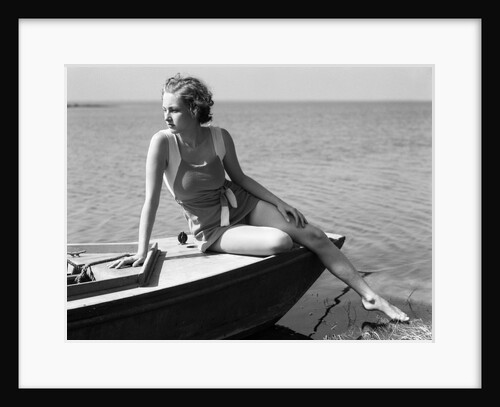 Woman wearing one piece bathing suit sitting on edge of boat by Anonymous