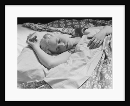 Sleeping blond woman hand over head asleep by Anonymous
