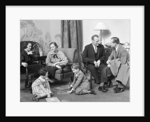 Family mother father two kids playing on floor visiting with another couple by Anonymous