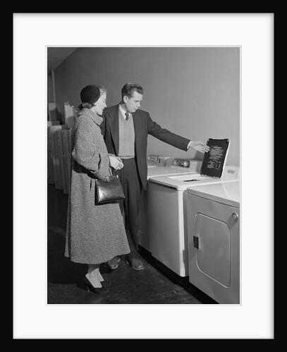 Young couple man woman shopping for washing machine by Anonymous