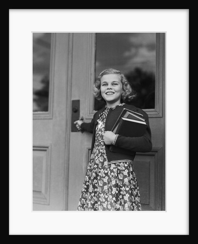Smiling girl print dress holding school books opening door by Anonymous