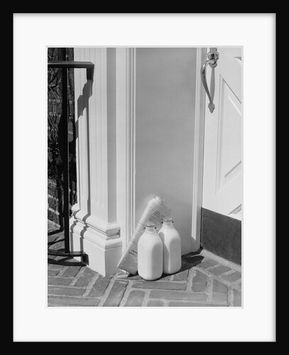 Glass milk bottles and newspaper by front door home delivery by Anonymous