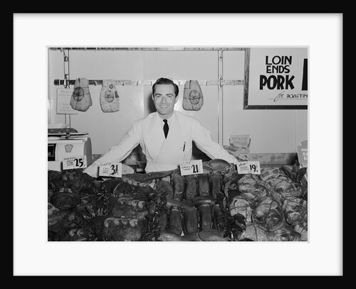 Portrait smiling man butcher grocer at meat counter by Anonymous