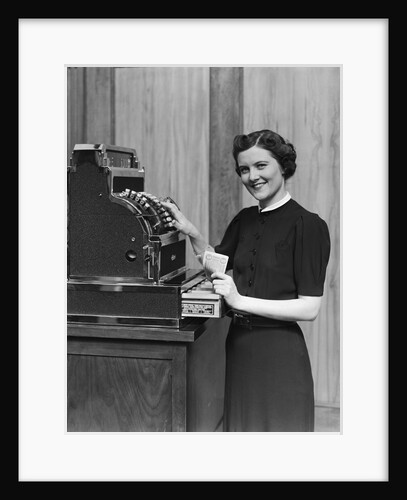 Smiling sales woman ringing up sale on cash register by Anonymous