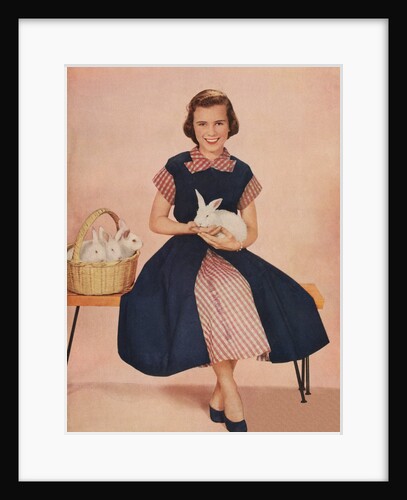 Girl holding rabbit by Anonymous