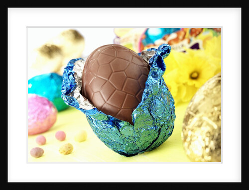Chocolate Easter egg with opened foil by Anonymous