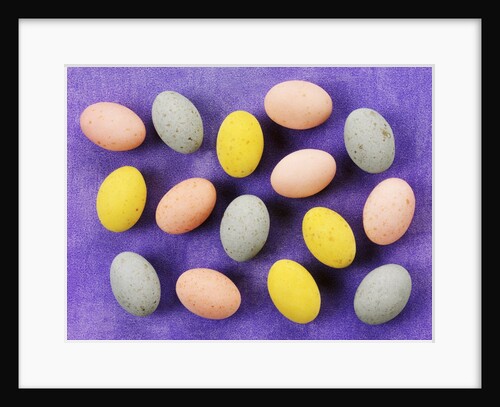 Small coloured Easter eggs on purple background by Anonymous