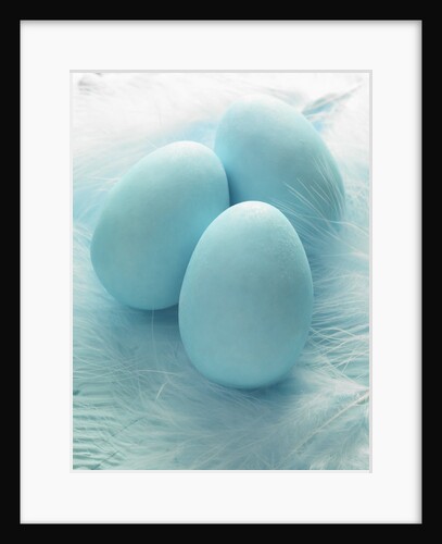 Three blue Easter eggs on feathers by Anonymous