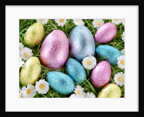 Chocolate Easter eggs in coloured foil in grass by Anonymous