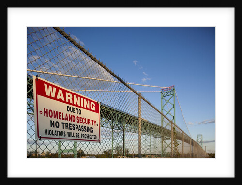 No trespassing sign on fence by the Ambassador Bridge by Anonymous